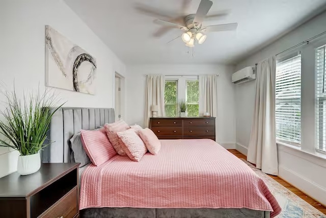 412 Merrill St, Houston, TX 77009 - bedroom with multiple windows, a wall mounted AC, and wood finished floors