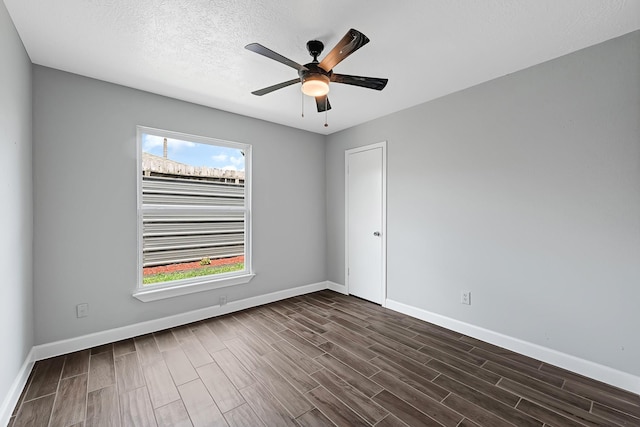 8910 Beau Monde Dr, Houston, TX 77099 - unfurnished room with plenty of natural light, dark wood-style flooring, baseboards, and a textured ceiling