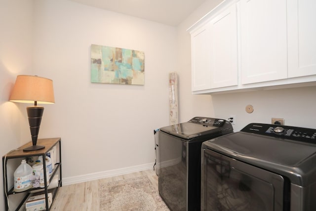 10134 Blythe St, Rosharon, TX 77583 - laundry area featuring cabinet space, washing machine and dryer, light wood-style flooring, and baseboards