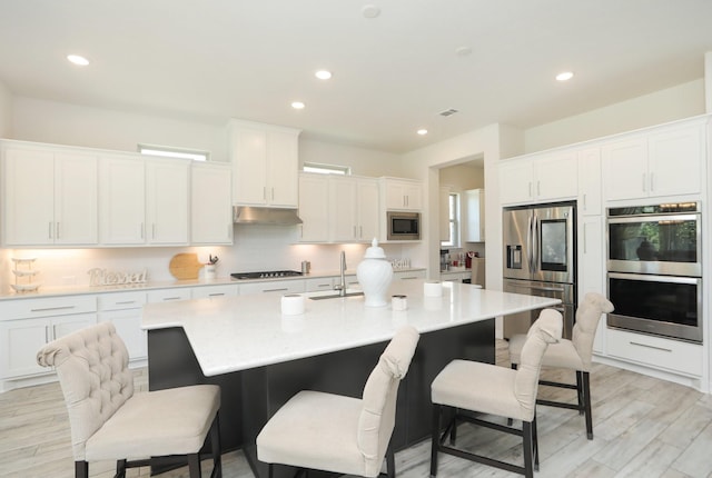 10134 Blythe St, Rosharon, TX 77583 - kitchen with stainless steel appliances, white cabinetry, and recessed lighting