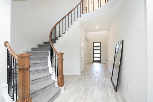 10134 Blythe St, Rosharon, TX 77583 - entrance foyer with stairs, wood finished floors, a towering ceiling, and baseboards
