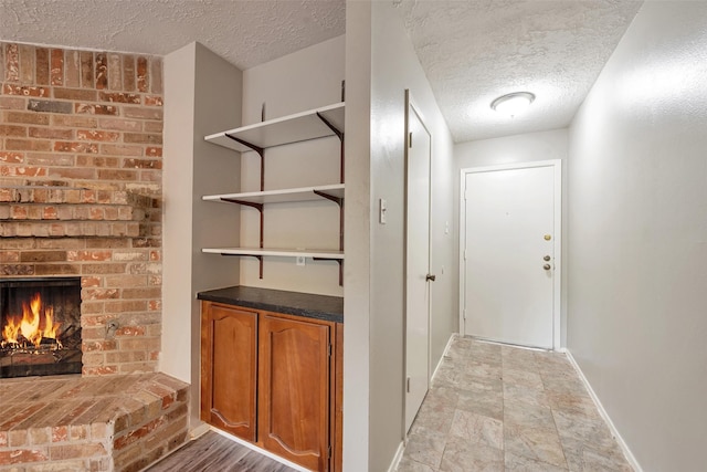 9507 Rannock Way, Spring, TX 77379 - wine room with a textured ceiling, baseboards, and a fireplace