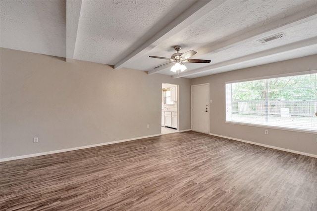 9507 Rannock Way, Spring, TX 77379 - spare room featuring wood finished floors, healthy amount of natural light, baseboards, a textured ceiling, and a ceiling fan