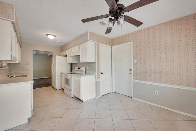 9507 Rannock Way, Spring, TX 77379 - kitchen with white appliances, a sink, light tile patterned flooring, a ceiling fan, and white cabinetry