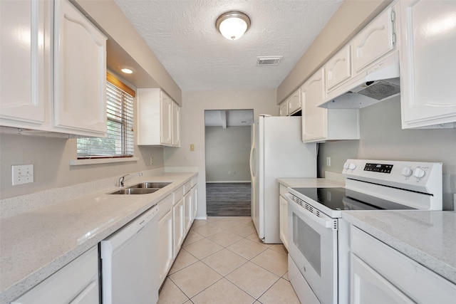 9507 Rannock Way, Spring, TX 77379 - kitchen featuring white appliances, a sink, under cabinet range hood, white cabinets, and a textured ceiling