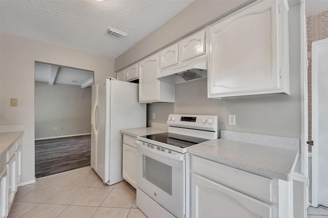 9507 Rannock Way, Spring, TX 77379 - kitchen with white appliances, under cabinet range hood, white cabinets, light countertops, and light tile patterned floors