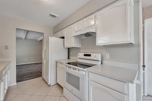 9507 Rannock Way, Spring, TX 77379 - kitchen with white appliances, under cabinet range hood, white cabinetry, light countertops, and light tile patterned flooring