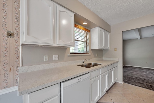 9507 Rannock Way, Spring, TX 77379 - kitchen featuring white dishwasher, a sink, white cabinets, light tile patterned floors, and a textured ceiling