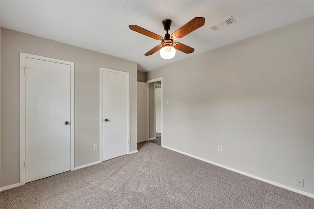 9507 Rannock Way, Spring, TX 77379 - unfurnished bedroom featuring carpet, baseboards, multiple closets, and ceiling fan