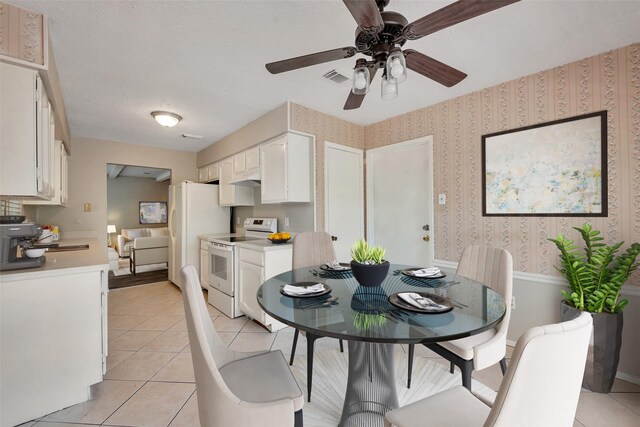 9507 Rannock Way, Spring, TX 77379 - dining area featuring light tile patterned floors, ceiling fan, and wallpapered walls