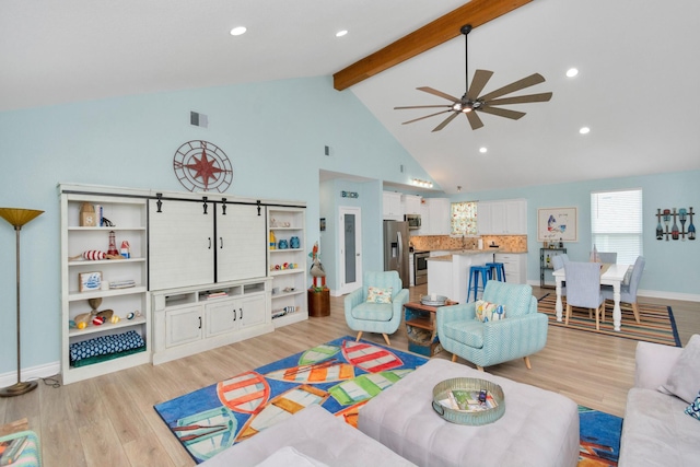 4019 Ector Dr, Galveston, TX 77554 - living area featuring light wood-type flooring, beamed ceiling, baseboards, a ceiling fan, and high vaulted ceiling