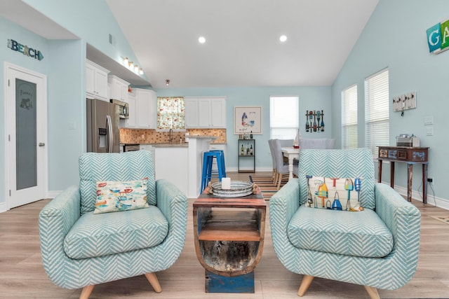 4019 Ector Dr, Galveston, TX 77554 - living room with light wood-style floors, baseboards, recessed lighting, and high vaulted ceiling