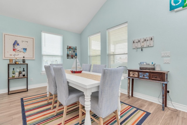 4019 Ector Dr, Galveston, TX 77554 - dining room featuring light wood-style flooring, vaulted ceiling, and baseboards