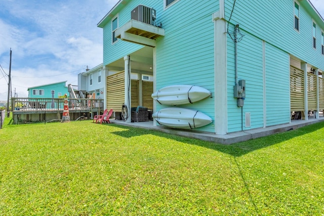 4019 Ector Dr, Galveston, TX 77554 - view of side of home with central AC and a lawn
