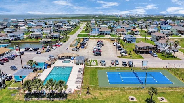 4019 Ector Dr, Galveston, TX 77554 - aerial perspective of suburban area with a pool and a nearby body of water