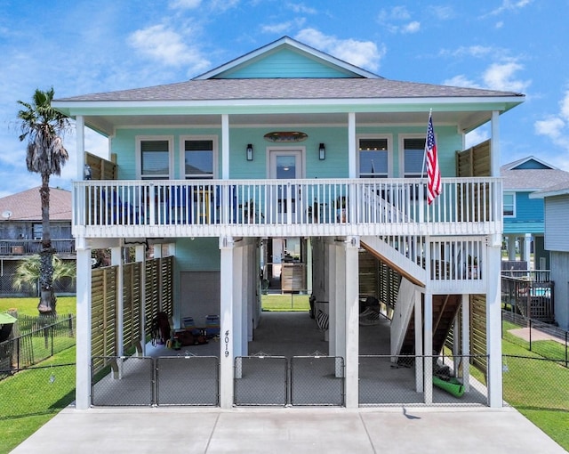4019 Ector Dr, Galveston, TX 77554 - beach home with a porch, a shingled roof, a carport, concrete driveway, and stairs