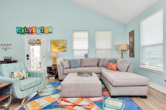 4019 Ector Dr, Galveston, TX 77554 - living area featuring wood finished floors, plenty of natural light, vaulted ceiling, and baseboards