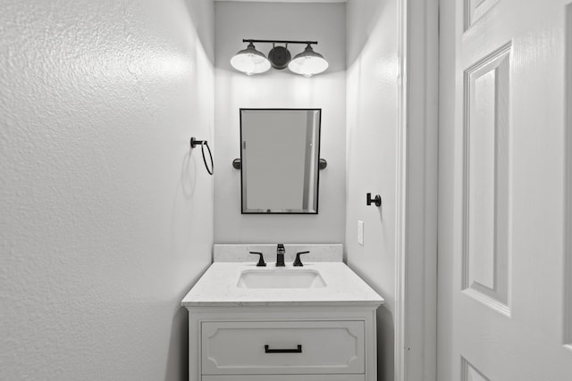 137 E Summerhaze Cir, The Woodlands, TX 77382 - bathroom with vanity and a textured wall