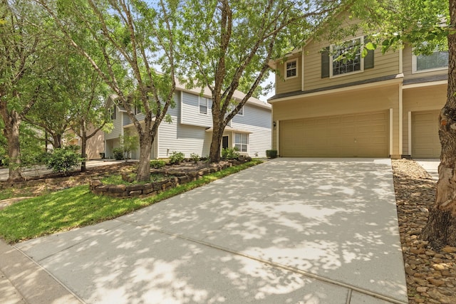 137 E Summerhaze Cir, The Woodlands, TX 77382 - view of front of house featuring a garage and concrete driveway