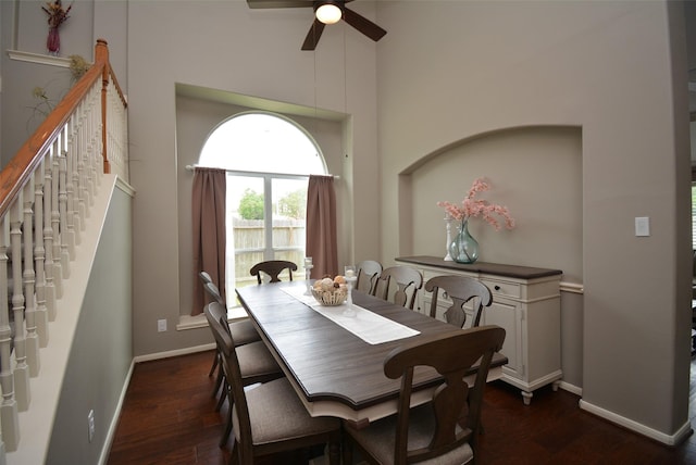 19026 Rustling Ridge Ln, Tomball, TX 77377 - dining room featuring ceiling fan, dark wood-style flooring, a towering ceiling, and stairs
