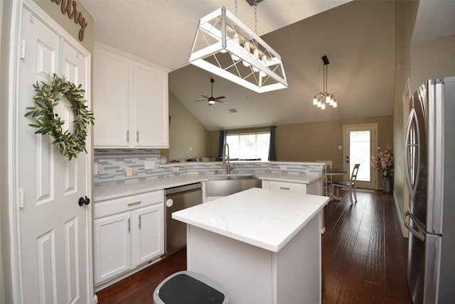 19026 Rustling Ridge Ln, Tomball, TX 77377 - kitchen featuring appliances with stainless steel finishes, a peninsula, backsplash, white cabinets, and high vaulted ceiling