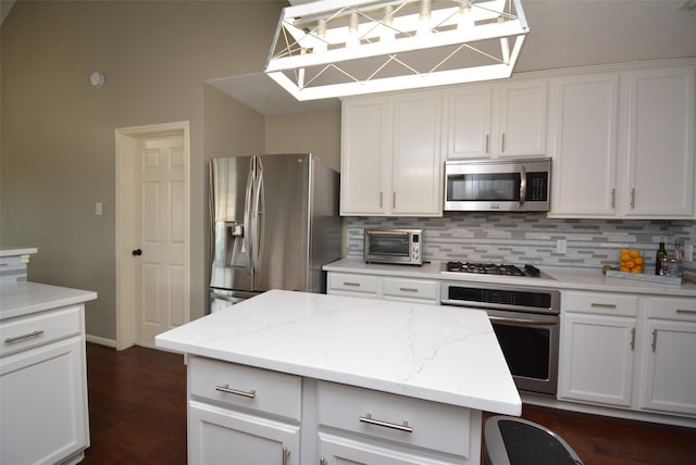 19026 Rustling Ridge Ln, Tomball, TX 77377 - kitchen featuring stainless steel appliances, backsplash, and white cabinets