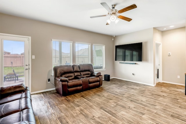 22624 Theodoli Dr, Katy, TX 77449 - living area featuring light wood-style floors, a ceiling fan, and baseboards