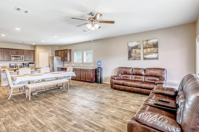 22624 Theodoli Dr, Katy, TX 77449 - living area with light wood-type flooring, a ceiling fan, recessed lighting, and baseboards