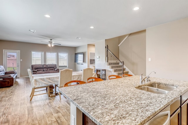 22624 Theodoli Dr, Katy, TX 77449 - kitchen with a sink, open floor plan, light wood-style flooring, recessed lighting, and a ceiling fan