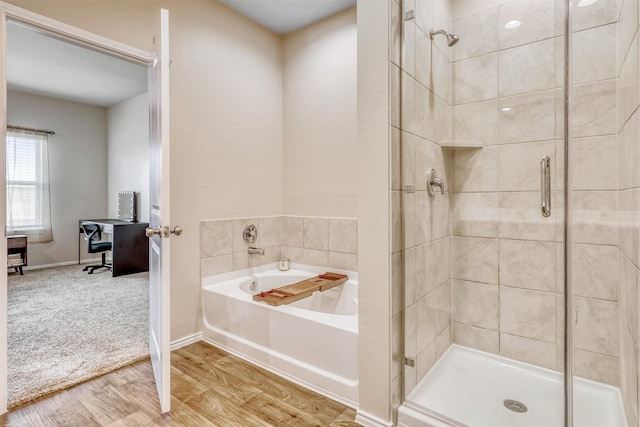 22624 Theodoli Dr, Katy, TX 77449 - bathroom featuring a shower stall, a garden tub, wood finished floors, and baseboards