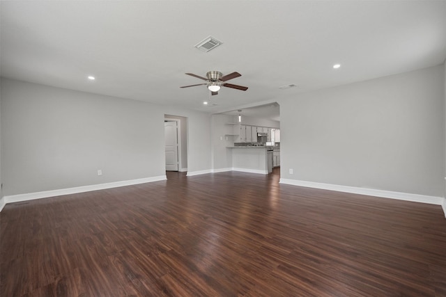 10134 Palestine St, Houston, TX 77029 - unfurnished living room with ceiling fan, baseboards, recessed lighting, and dark wood-style flooring
