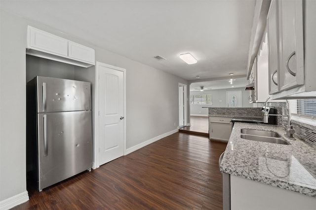 10134 Palestine St, Houston, TX 77029 - kitchen with freestanding refrigerator, baseboards, and dark wood-style floors