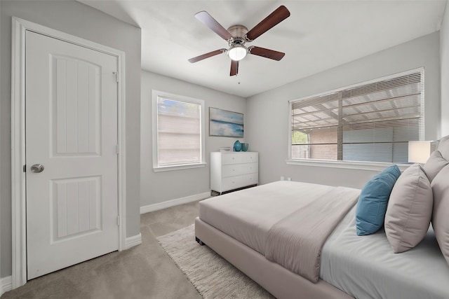 10134 Palestine St, Houston, TX 77029 - bedroom featuring light colored carpet, baseboards, multiple windows, and a ceiling fan
