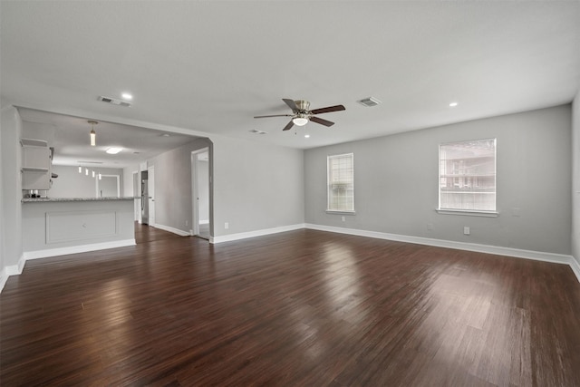 10134 Palestine St, Houston, TX 77029 - unfurnished living room featuring ceiling fan, recessed lighting, dark wood-style floors, and baseboards