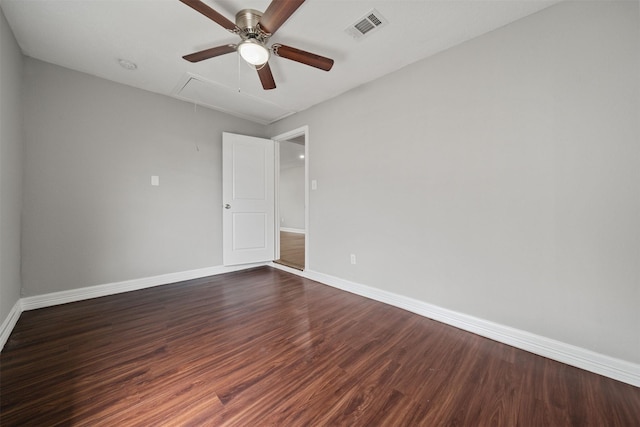 10134 Palestine St, Houston, TX 77029 - spare room featuring attic access, a ceiling fan, dark wood-style flooring, and baseboards