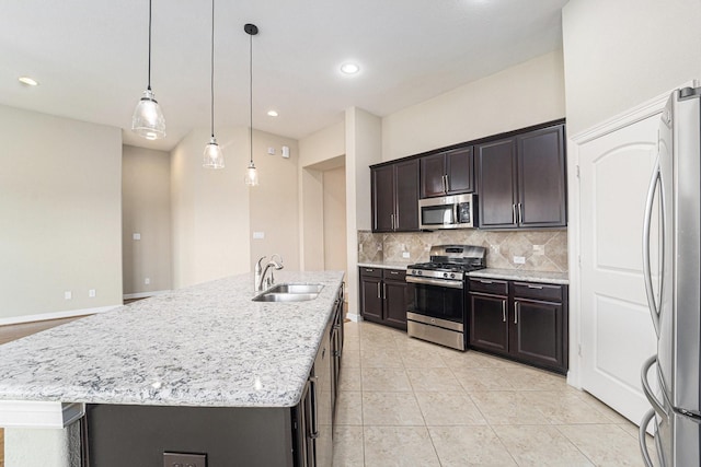 17127 Verde Park Ln, Cypress, TX 77433 - kitchen with appliances with stainless steel finishes, a sink, decorative backsplash, light tile patterned floors, and pendant lighting