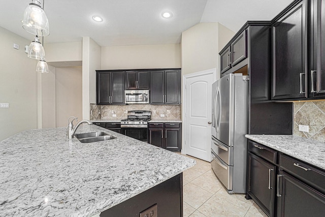17127 Verde Park Ln, Cypress, TX 77433 - kitchen with stainless steel appliances, a sink, decorative backsplash, light stone countertops, and pendant lighting