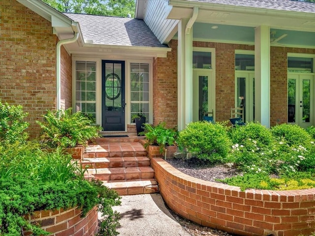 1908 Columbine Dr, Lufkin, TX 75904 - view of exterior entry featuring french doors, brick siding, and a shingled roof