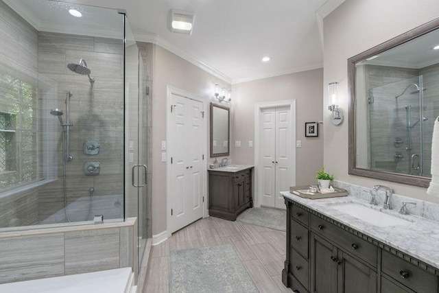1908 Columbine Dr, Lufkin, TX 75904 - bathroom featuring a shower stall, two vanities, ornamental molding, and recessed lighting