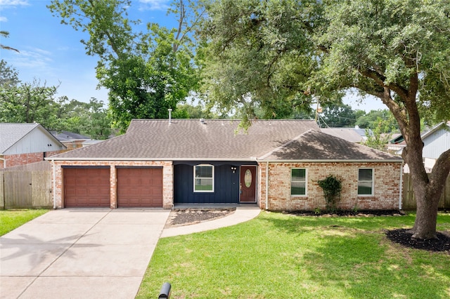 5000 Old Castle Ln, Dickinson, TX 77539 - single story home with a garage, driveway, roof with shingles, and brick siding