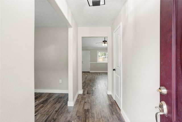 5000 Old Castle Ln, Dickinson, TX 77539 - corridor featuring dark wood-type flooring, baseboards, and a textured ceiling