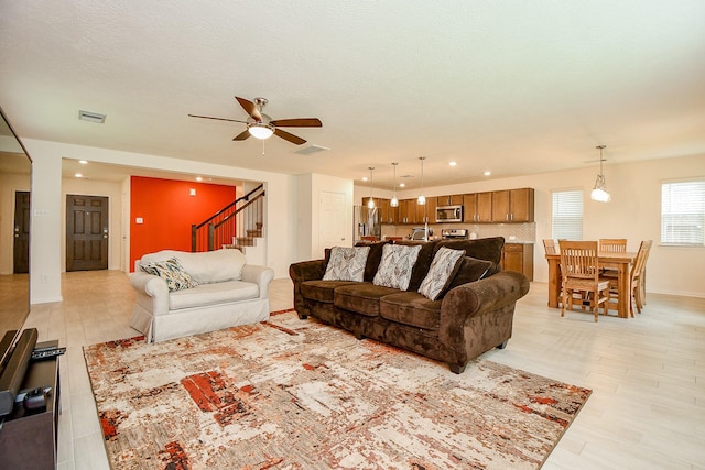 4827 Ranleagh Ct, Katy, TX 77493 - living room featuring ceiling fan, stairway, light wood-type flooring, and recessed lighting