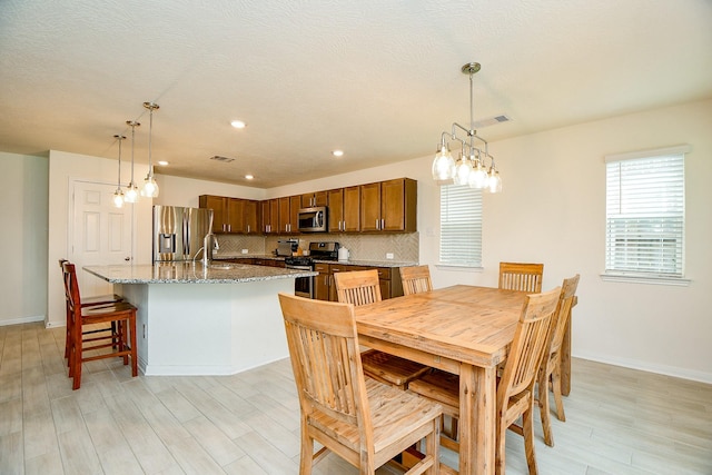 4827 Ranleagh Ct, Katy, TX 77493 - dining room featuring light wood finished floors, baseboards, recessed lighting, and a chandelier