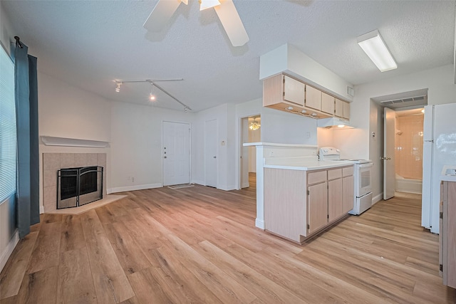 2750 Holly Hall St Unit 910, Houston, TX 77054 - kitchen featuring white appliances, light wood-type flooring, light countertops, ceiling fan, and open floor plan