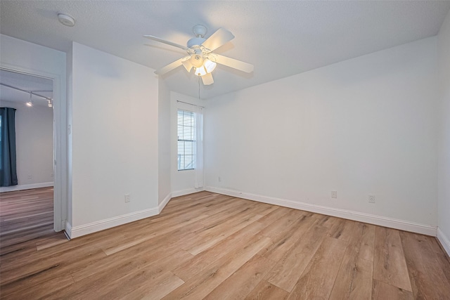 2750 Holly Hall St Unit 910, Houston, TX 77054 - spare room with a smoke detector, light wood finished floors, a ceiling fan, baseboards, and rail lighting