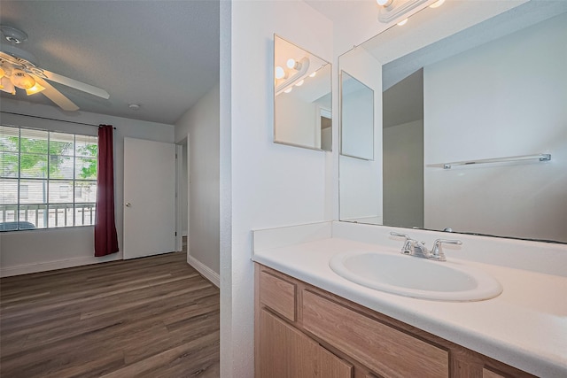 2750 Holly Hall St Unit 910, Houston, TX 77054 - bathroom featuring a ceiling fan, wood finished floors, baseboards, and vanity