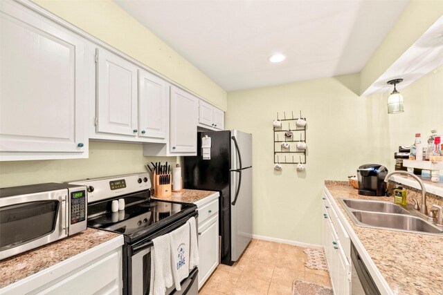 160 Peninsula Point Ter, Mabank, TX 75156 - kitchen with stainless steel appliances, a sink, white cabinets, light countertops, and light tile patterned floors