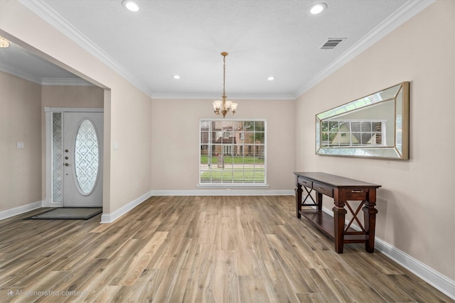 5523 Theall Rd, Houston, TX 77066 - foyer entrance with a chandelier, wood finished floors, baseboards, recessed lighting, and crown molding