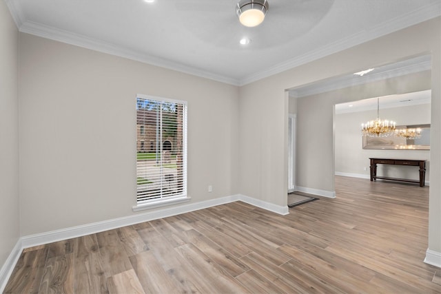 5523 Theall Rd, Houston, TX 77066 - empty room with a chandelier, wood finished floors, a ceiling fan, baseboards, and ornamental molding