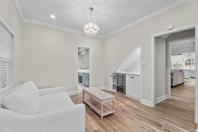 5523 Theall Rd, Houston, TX 77066 - living area featuring crown molding, light wood-style floors, a chandelier, baseboards, and wine cooler